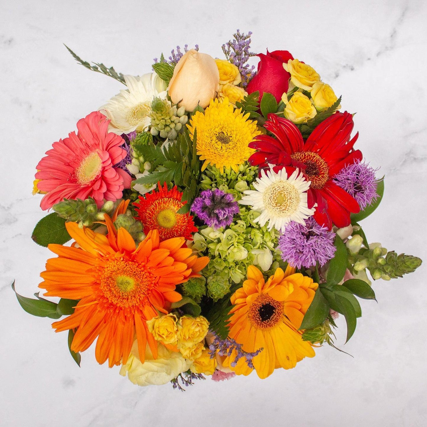 Arreglo floral de Gerberas Mix, Rosas Rojas, Rosas Peach Avalanche, Boca de Dragón y Estate Morada -GI025-