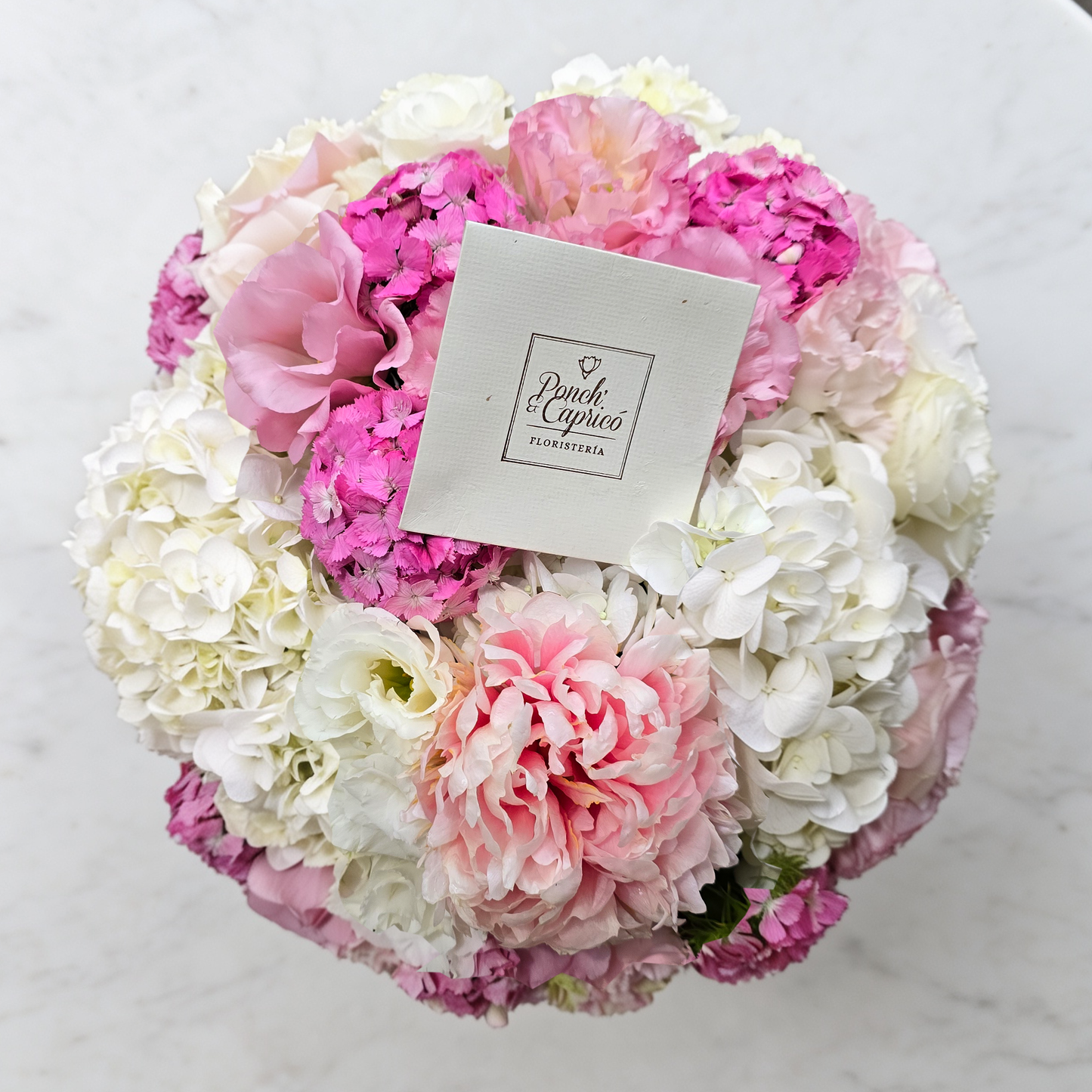 Vista superior del arreglo de peonías rosas, hortensias y lisianthus en caja rosa palo | flores CDMX