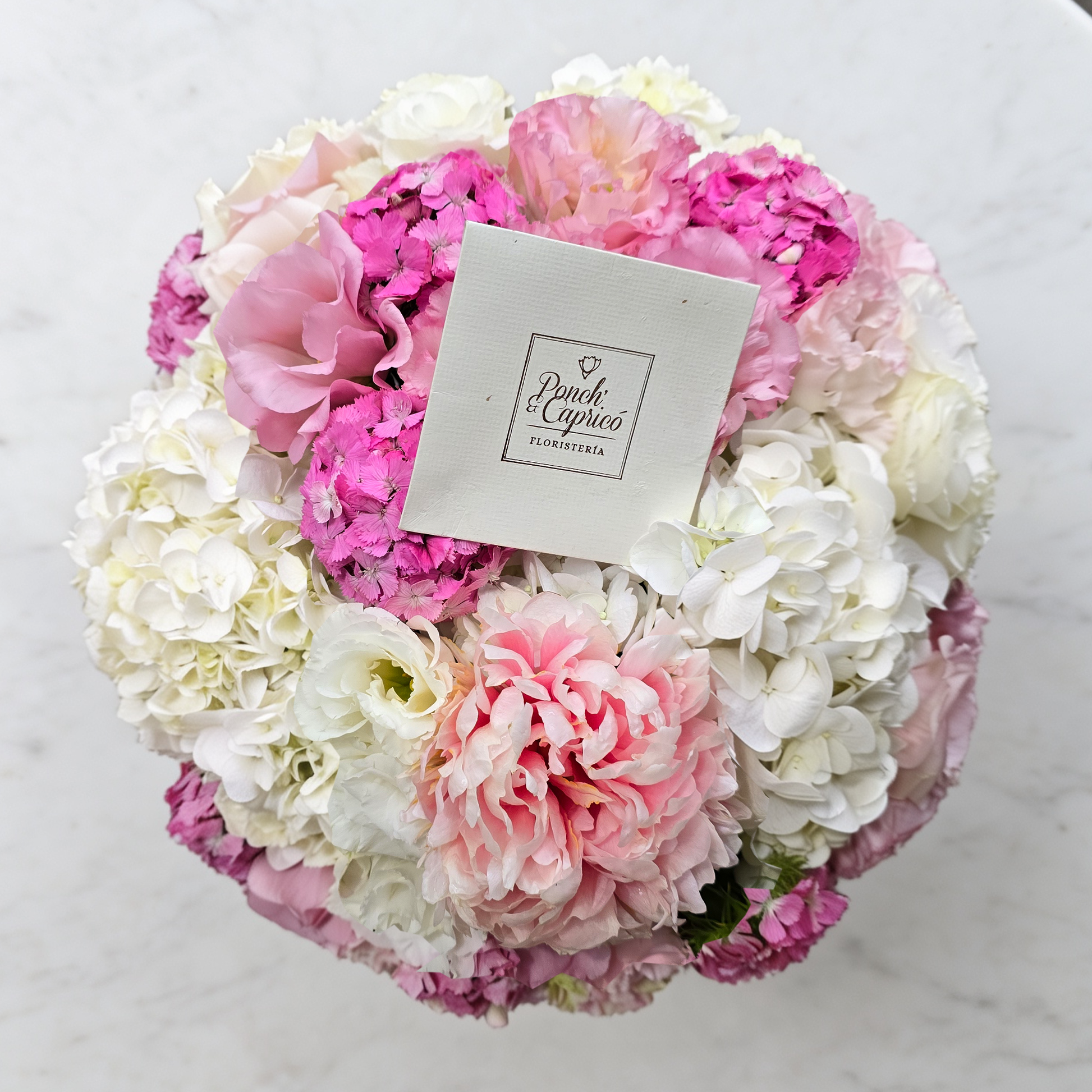Vista superior del arreglo de peonías rosas, hortensias y lisianthus en caja rosa palo | flores CDMX
