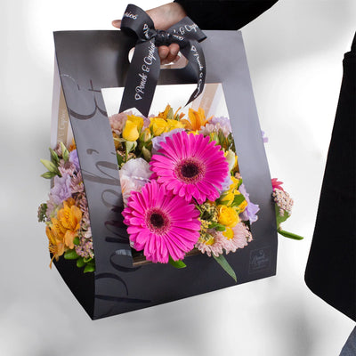 Flores en Caja tipo Canasta de Mini Rosas Amarillas, Gerberas Fucsia y Lisianthus Lila - PCAN029 -