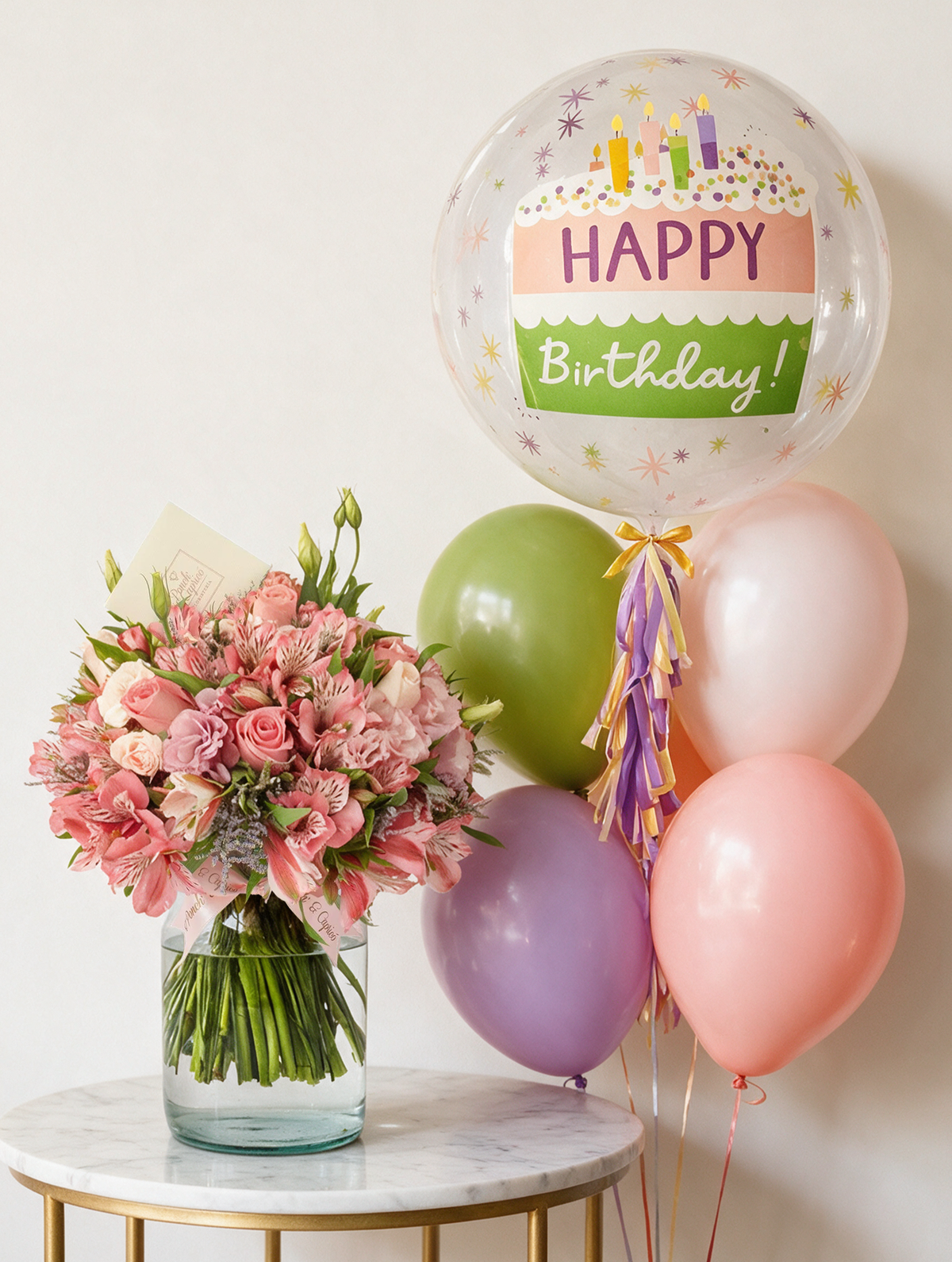 Set de regalo: arreglo floral de rosas y lisianthus en tonos románticos junto a una burbuja Happy Birthday con cinco globos látex pastel con helio